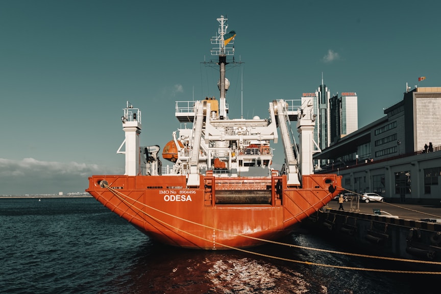 a large orange boat docked in the water