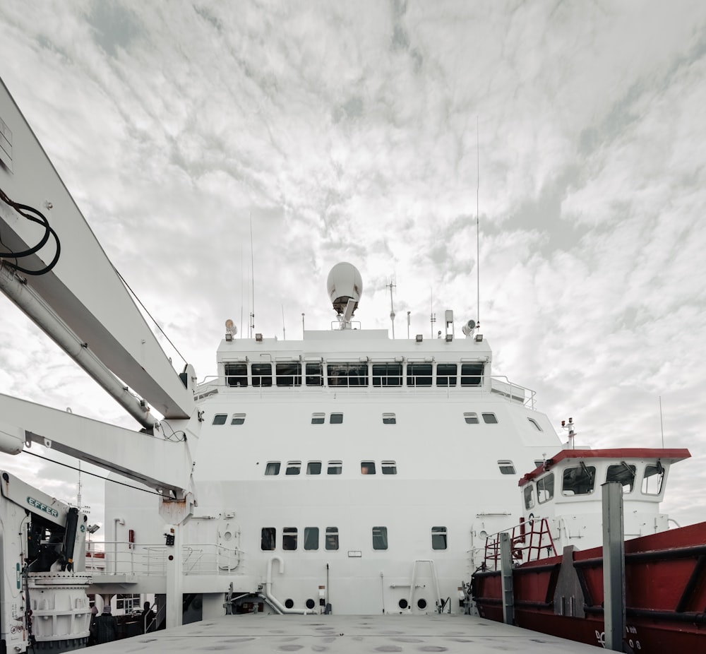 a large white boat docked at a pier