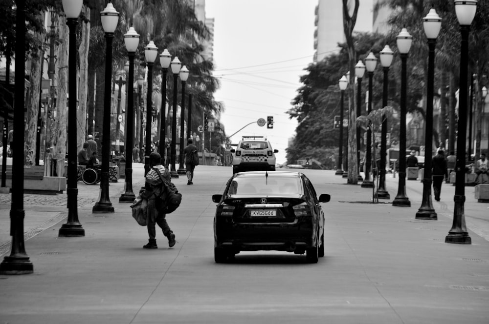 a black and white photo of a car on a street