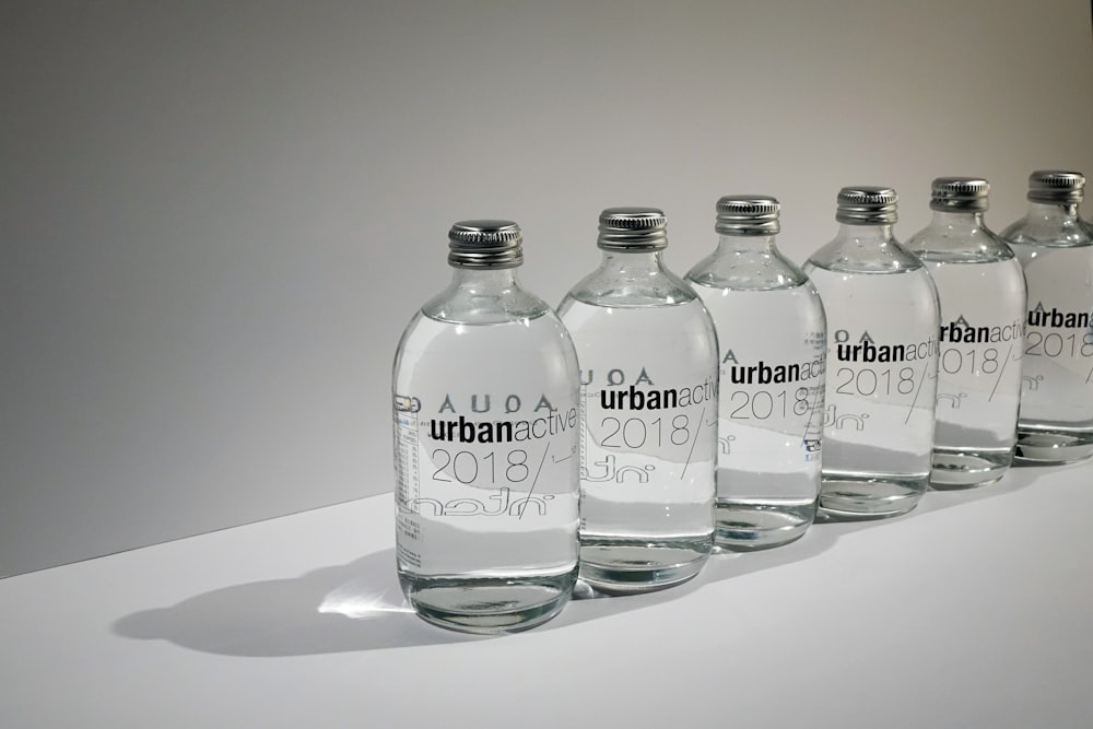 a row of bottles with names on them