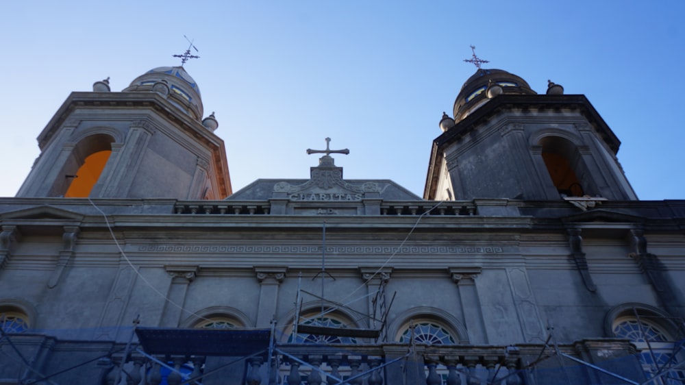 a church with two towers and a cross on top