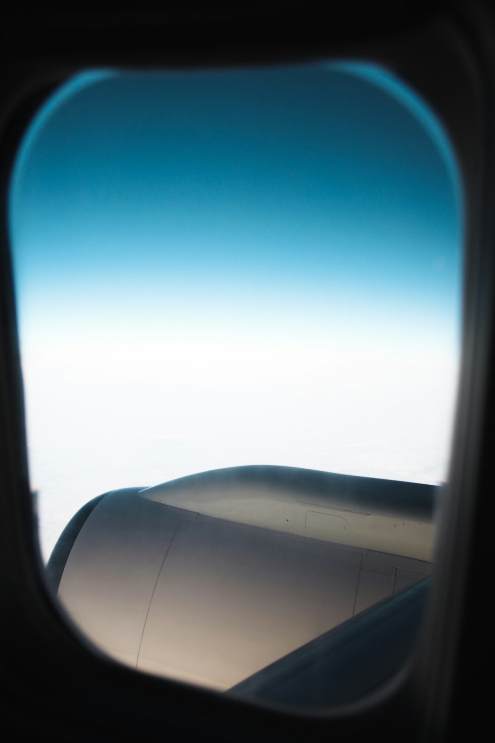 a view of the wing of an airplane through a window