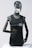 A metallic mannequin with a smooth, reflective head and dark, articulated arms is wearing a sleeveless shirt that reads 'personal trainer'. The mannequin stands upright against a plain light background, emphasizing the sleek design.