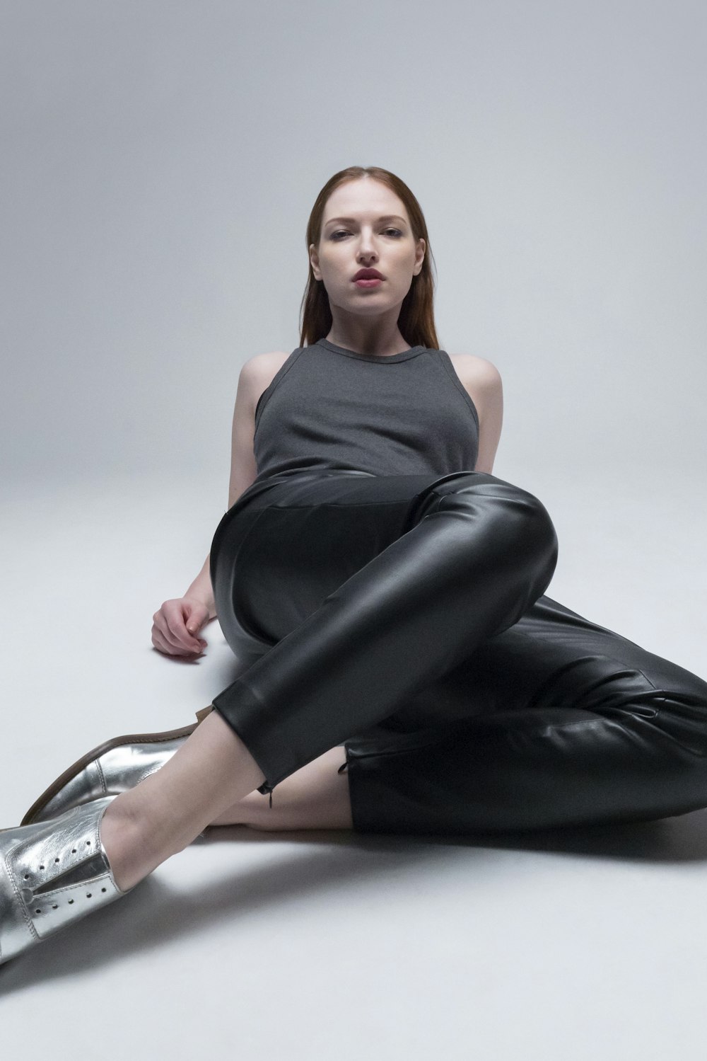 a woman sitting on the ground with her legs crossed