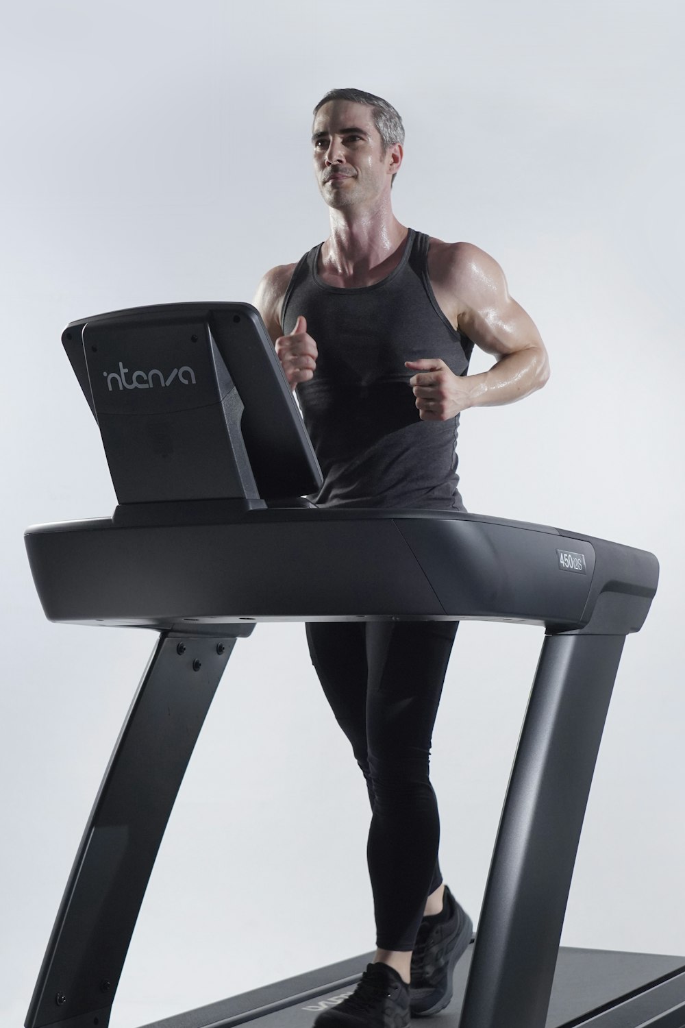 a man on a treadmill with a laptop