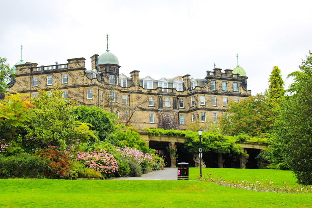 a large building with a green lawn in front of it