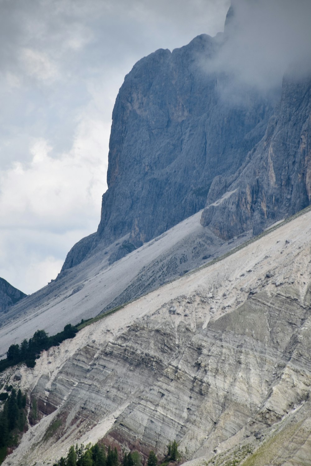 a large mountain with a very tall mountain in the background