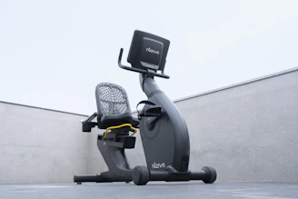 A sleek elliptical bike in a bright, modern home gym setting with natural light streaming in.