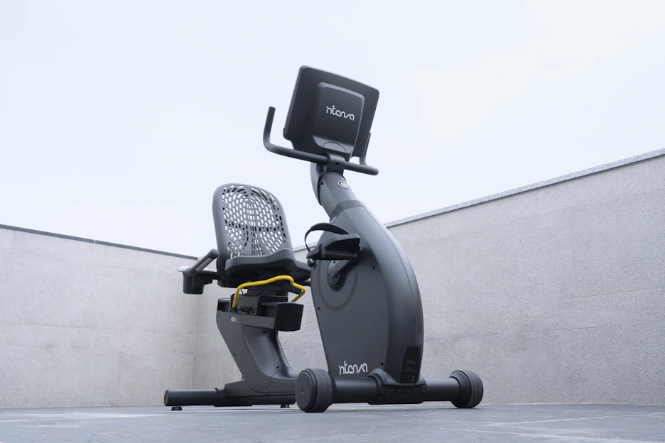 A sleek elliptical bike in a bright, modern home gym setting with natural light streaming in.