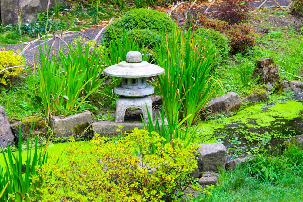 a stone lantern in the middle of a garden