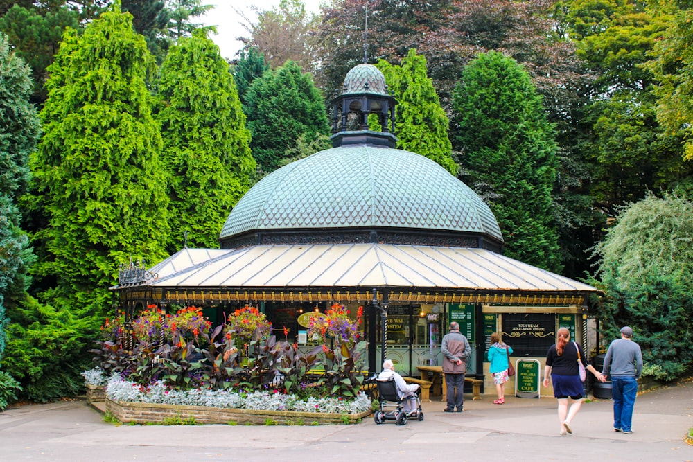 a group of people walking around a park