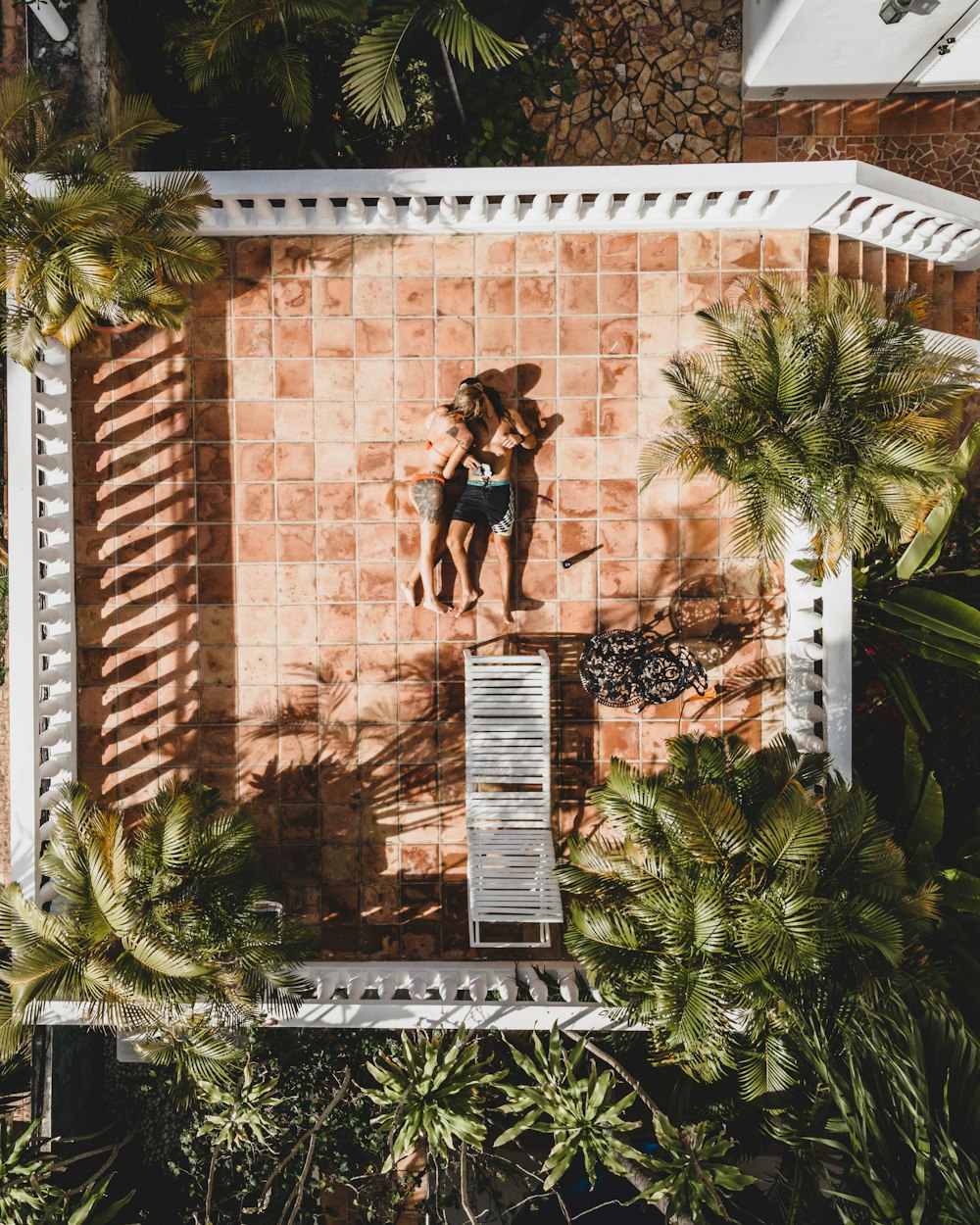 a woman in a bathing suit standing on a tiled wall