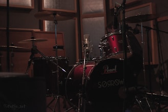 a drum set in a recording studio with sound equipment