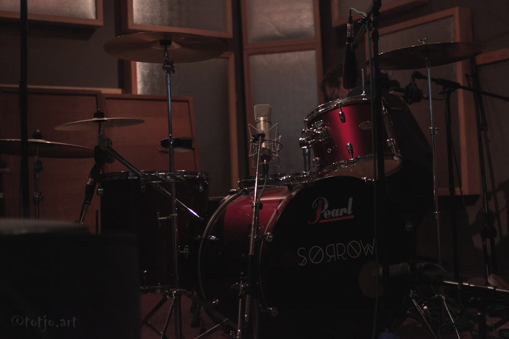 a drum set in a recording studio with sound equipment