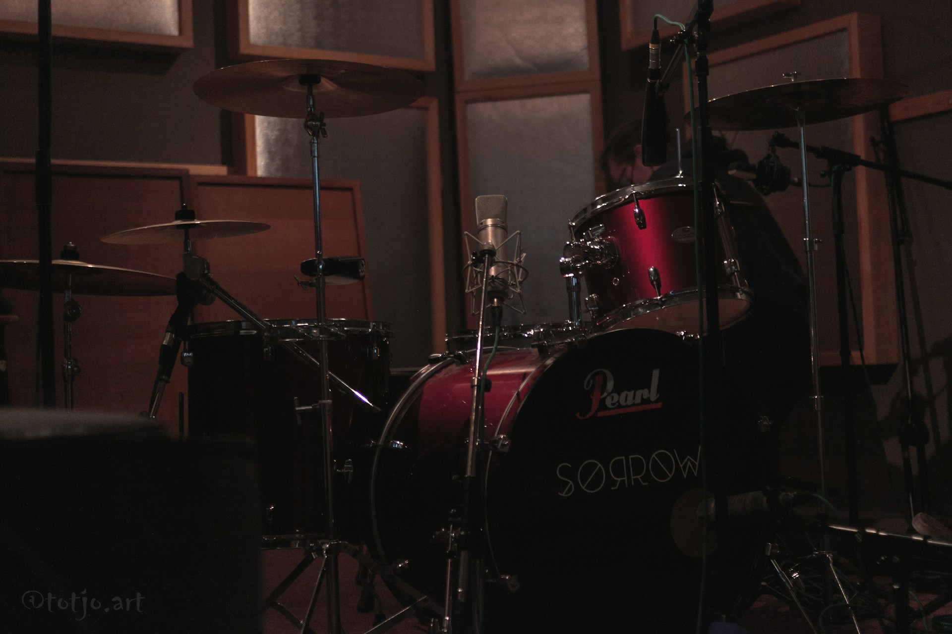a drum set in a recording studio with sound equipment