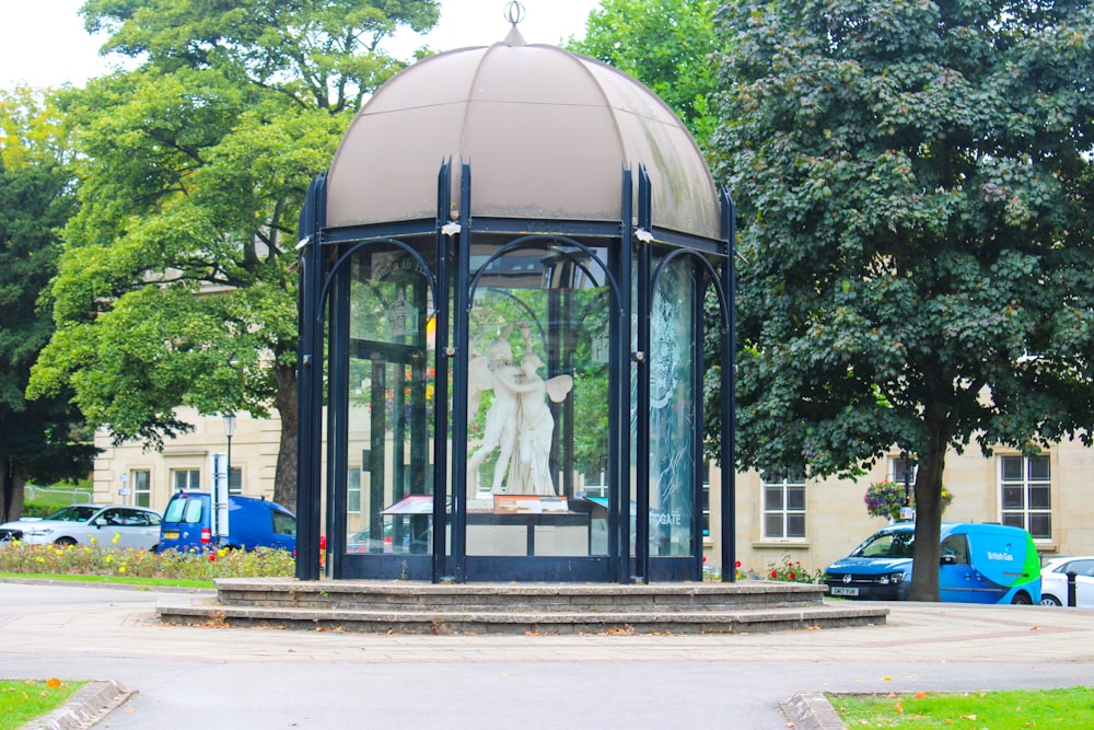 a gazebo with a statue of a woman in it