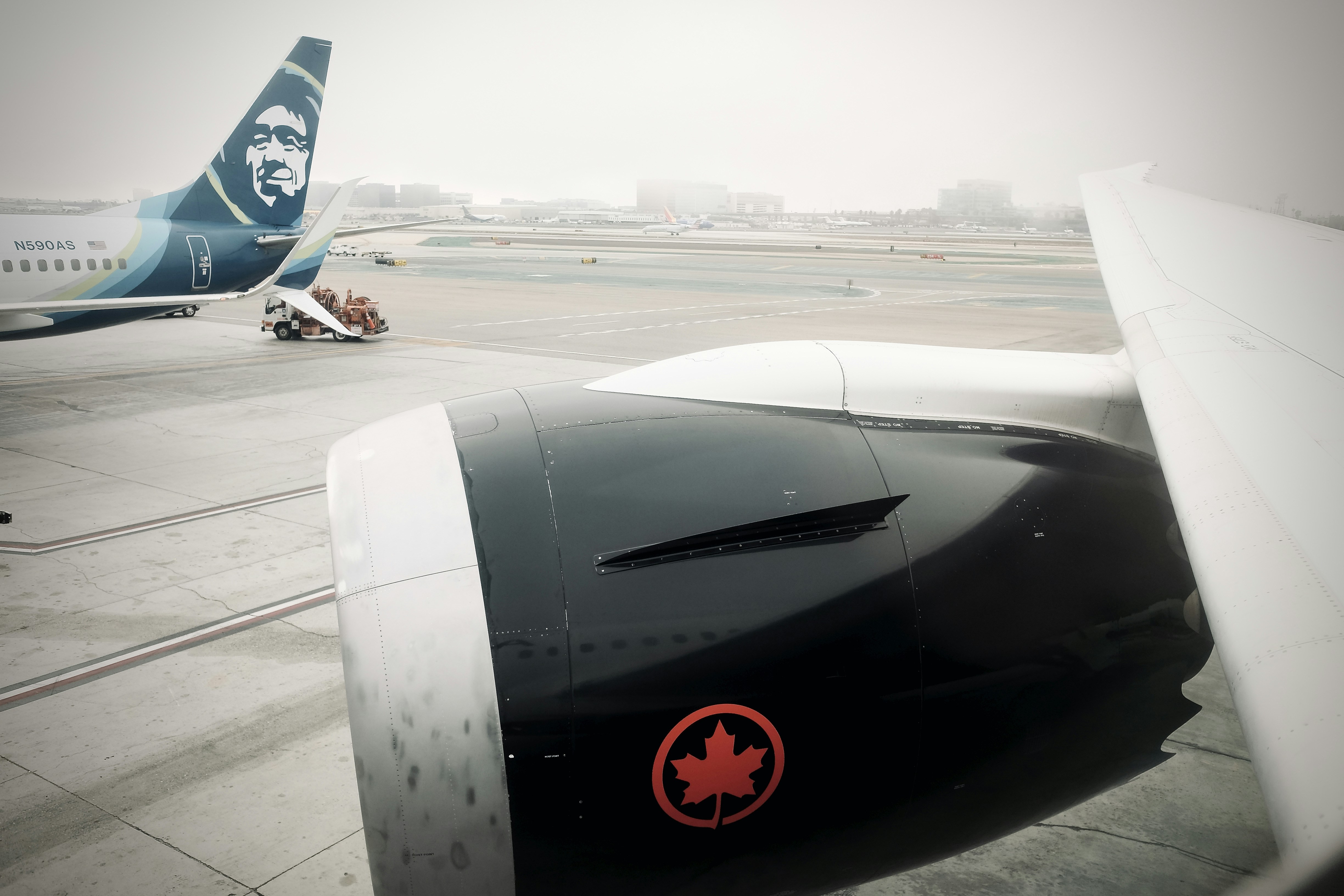 a jetliner sitting on top of an airport tarmac, 