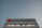 A large building facade with the Air Canada logo prominently displayed. The logo features a red maple leaf within a circle. The building is constructed from reflective materials and the scene is captured under a clear sky, suggesting a modern and corporate environment.