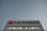 A large building facade with the Air Canada logo prominently displayed. The logo features a red maple leaf within a circle. The building is constructed from reflective materials and the scene is captured under a clear sky, suggesting a modern and corporate environment.