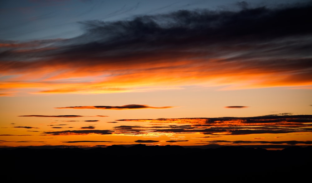 a sunset with clouds in the sky