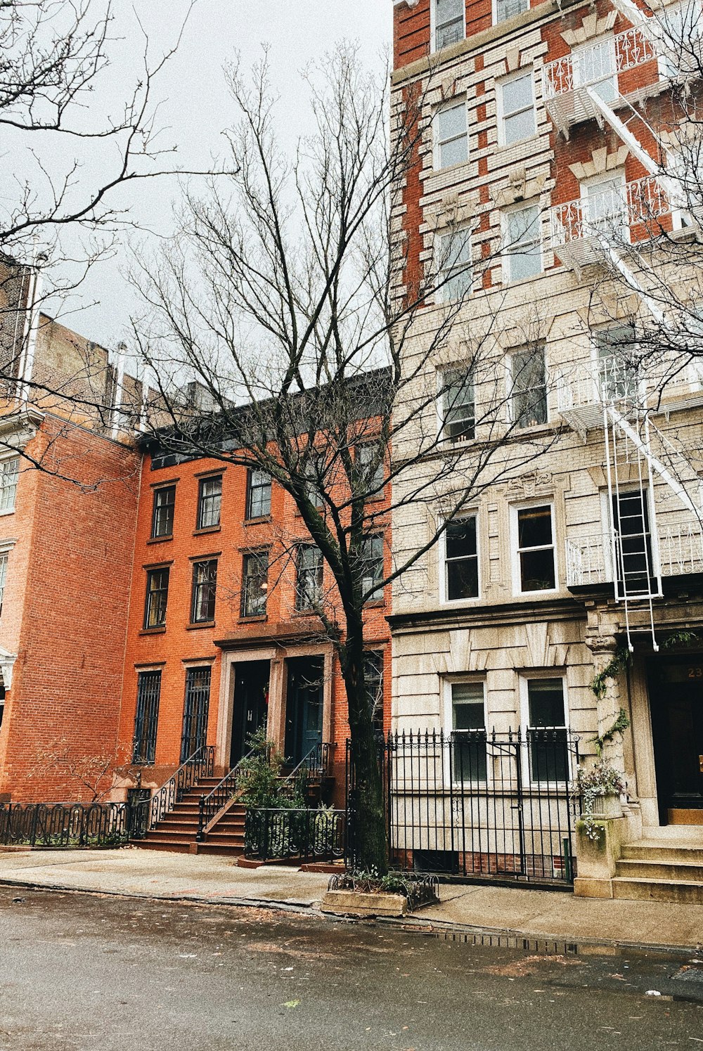 a tall brick building sitting next to a tree