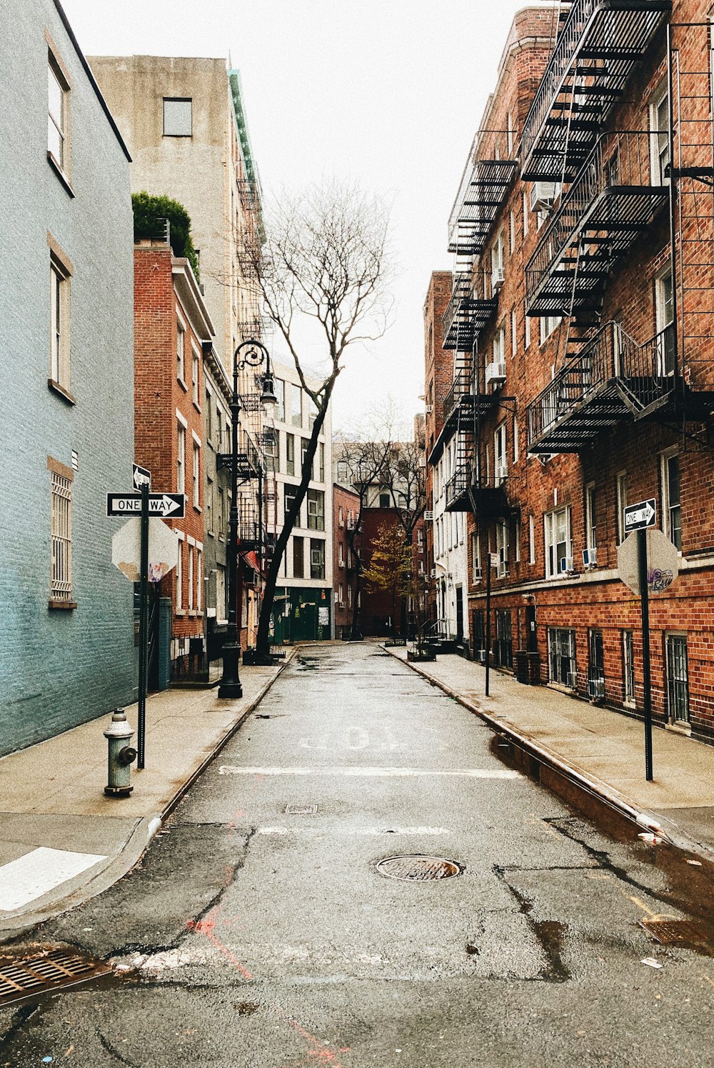 an empty street in a city with brick buildings