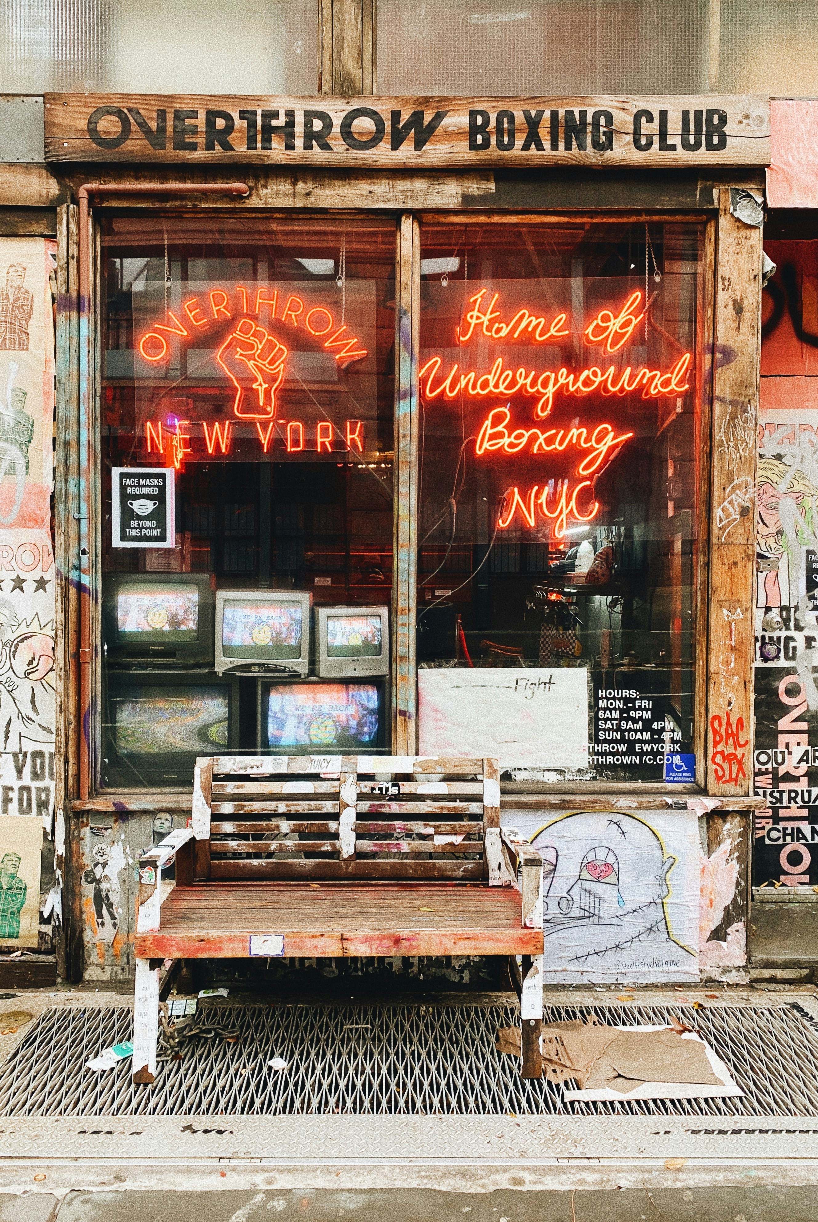 a wooden bench sitting in front of a building
