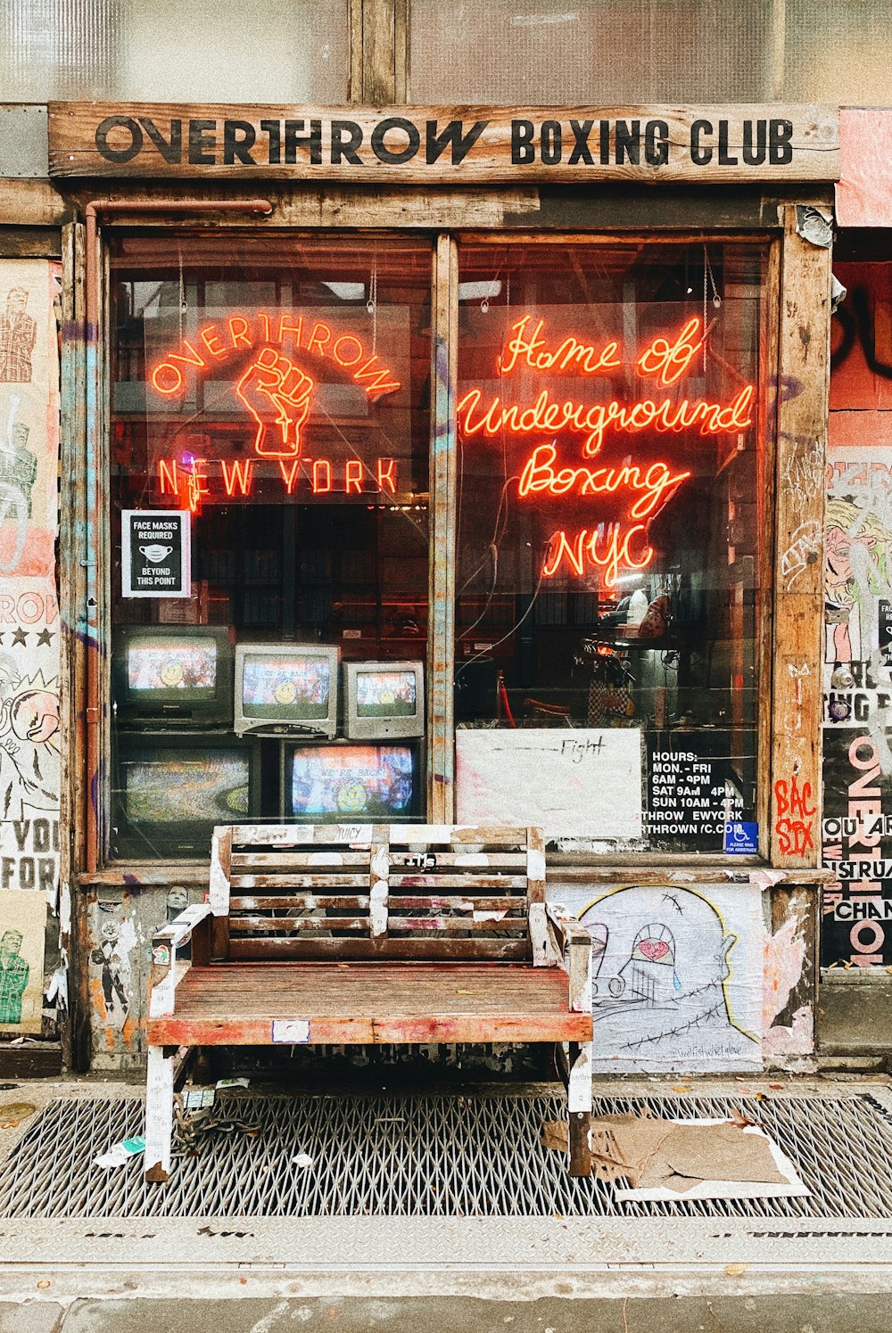 a wooden bench sitting in front of a building