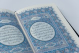 a close up of an open book with arabic writing