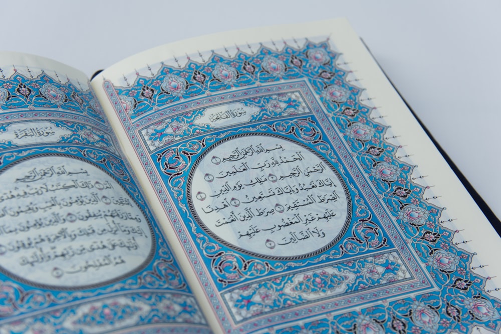 a close up of an open book with arabic writing