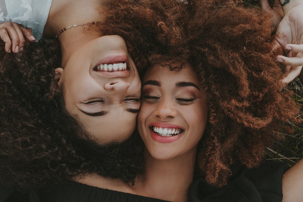 a couple of women laying next to each other