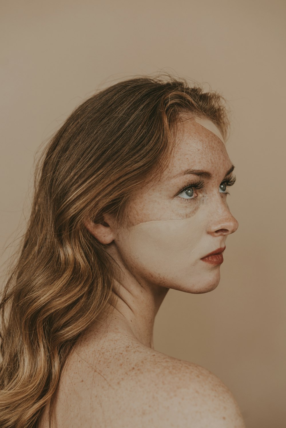 a woman with freckled hair and blue eyes