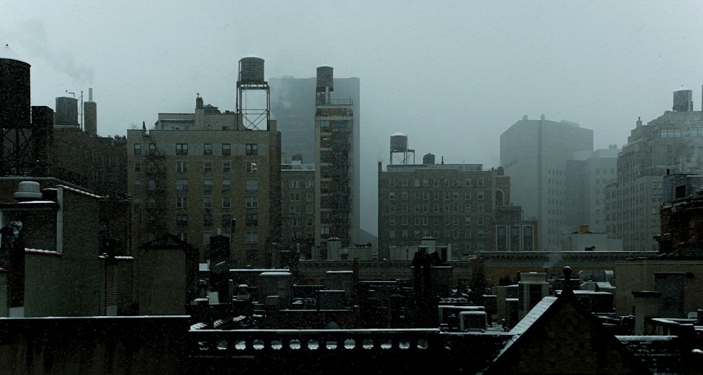 a view of a city from a rooftop in the snow