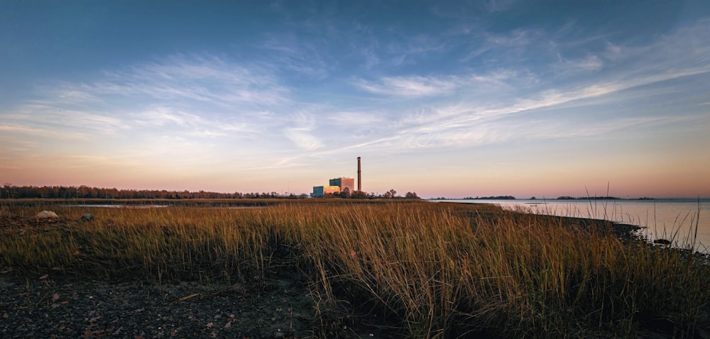 a view of a body of water with a factory in the background