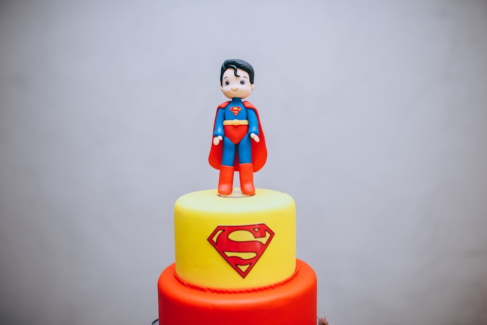 a cake with a superman figure on top of it