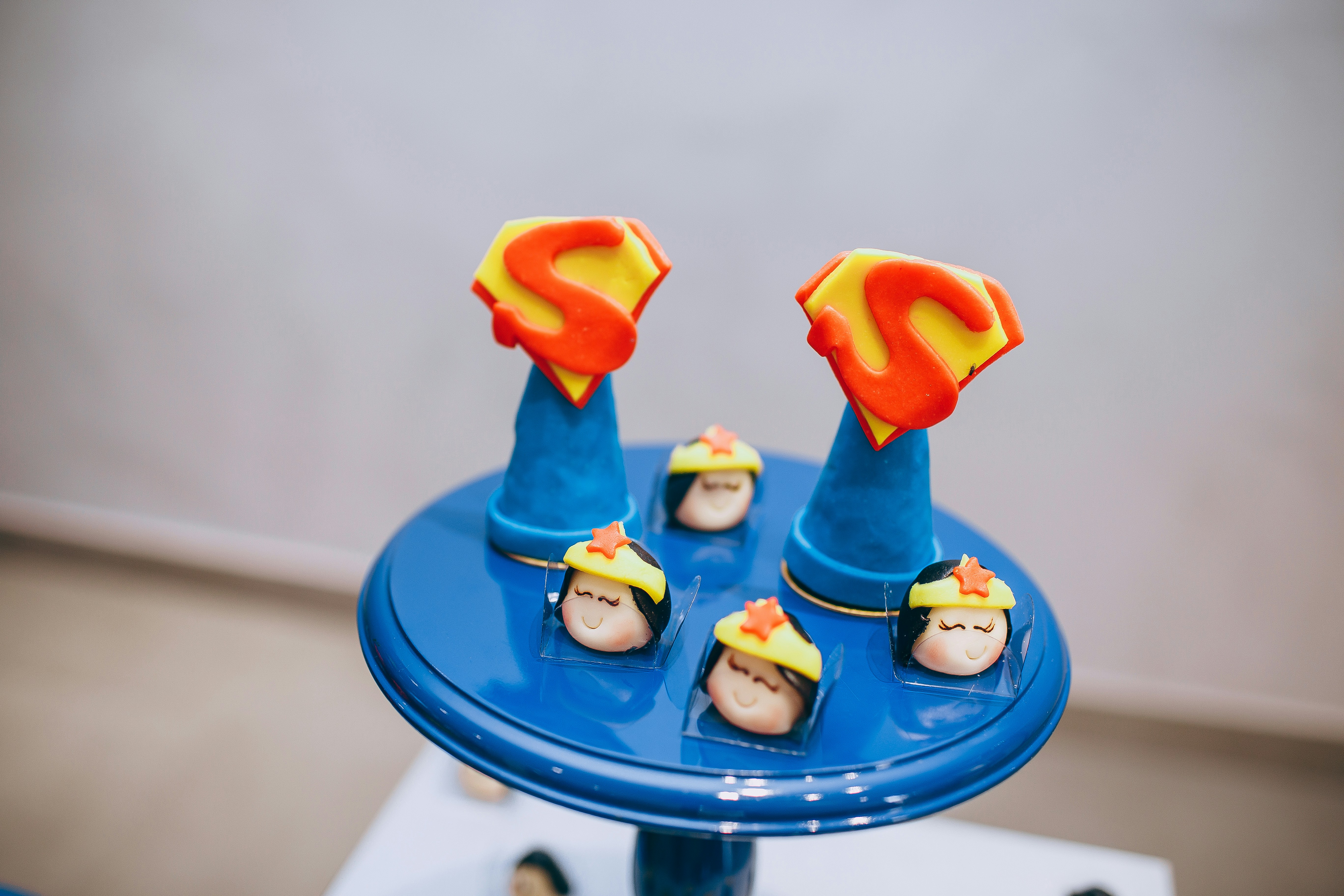 a blue table topped with a cake covered in fondant