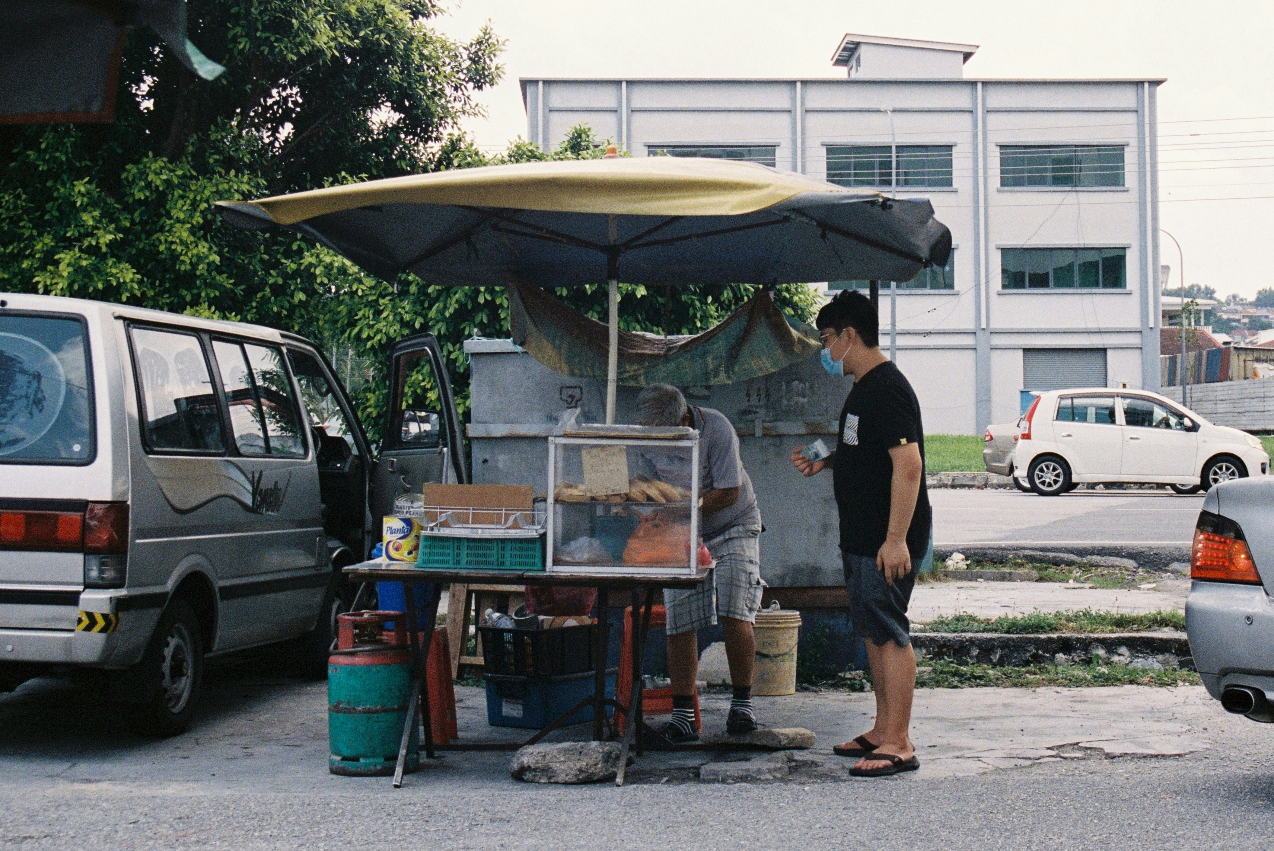 a couple of people that are standing under an umbrella