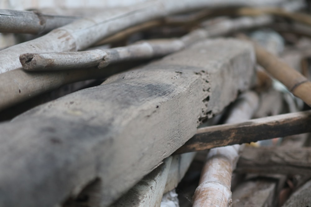 a close up of a pile of old wooden pipes