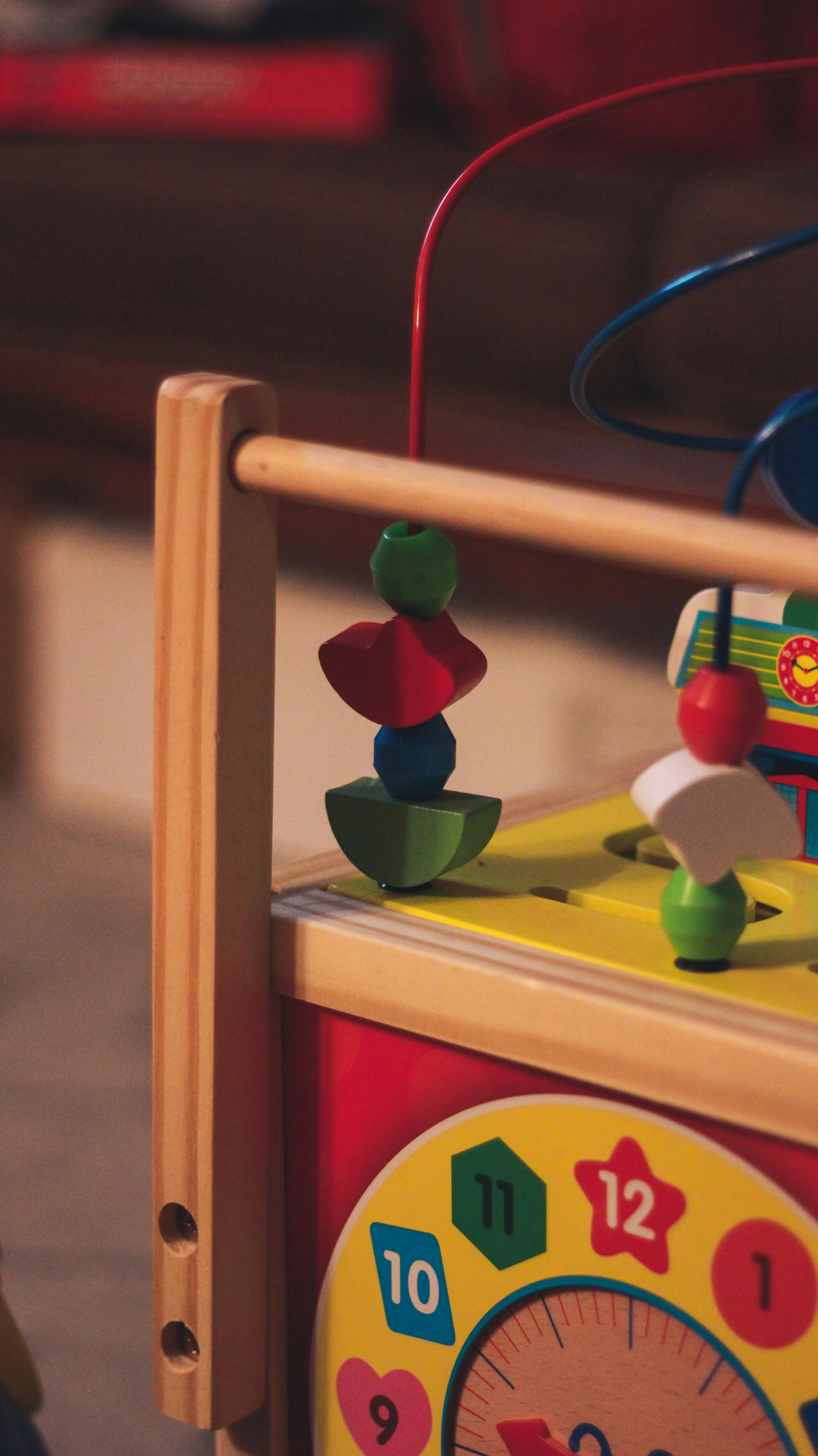 a wooden toy with a clock on top of it