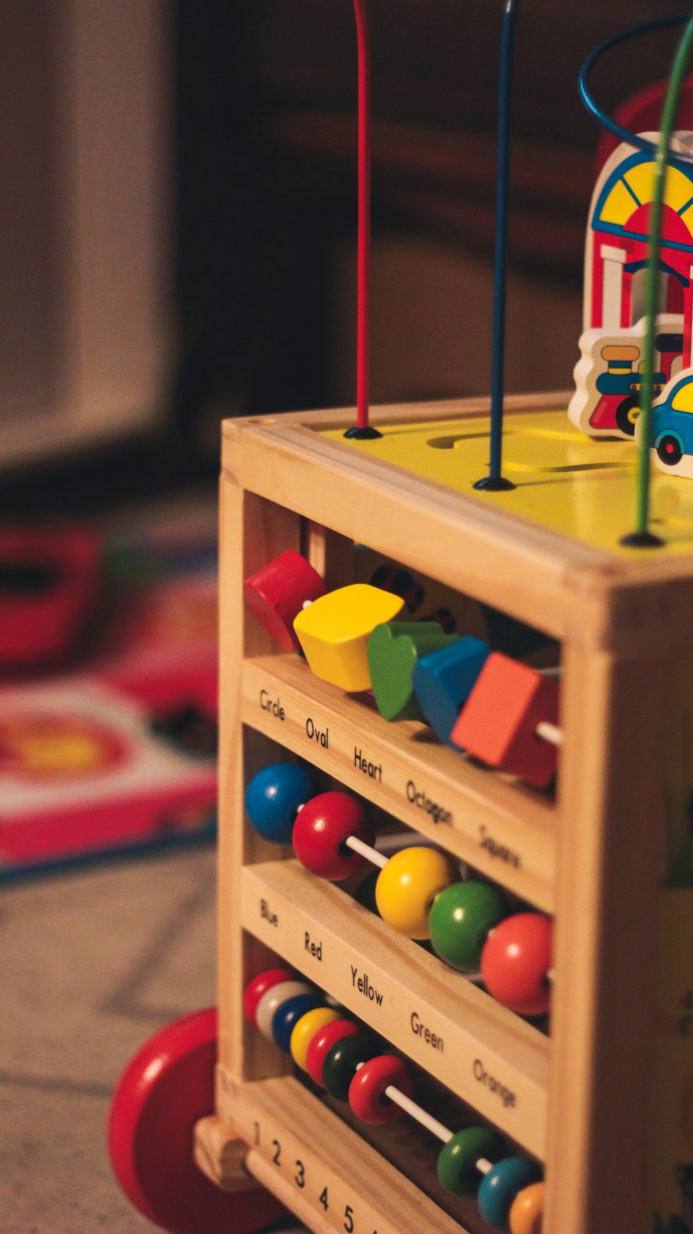 a wooden toy with lots of colorful toys on top of it