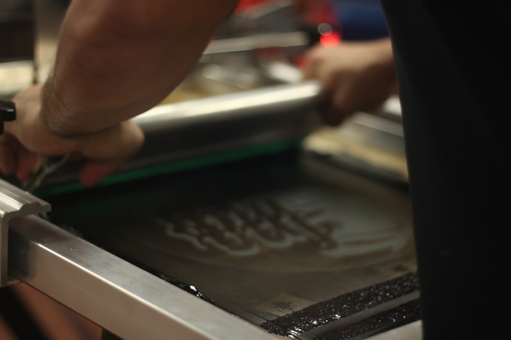 a person cutting something with a knife on a cutting board