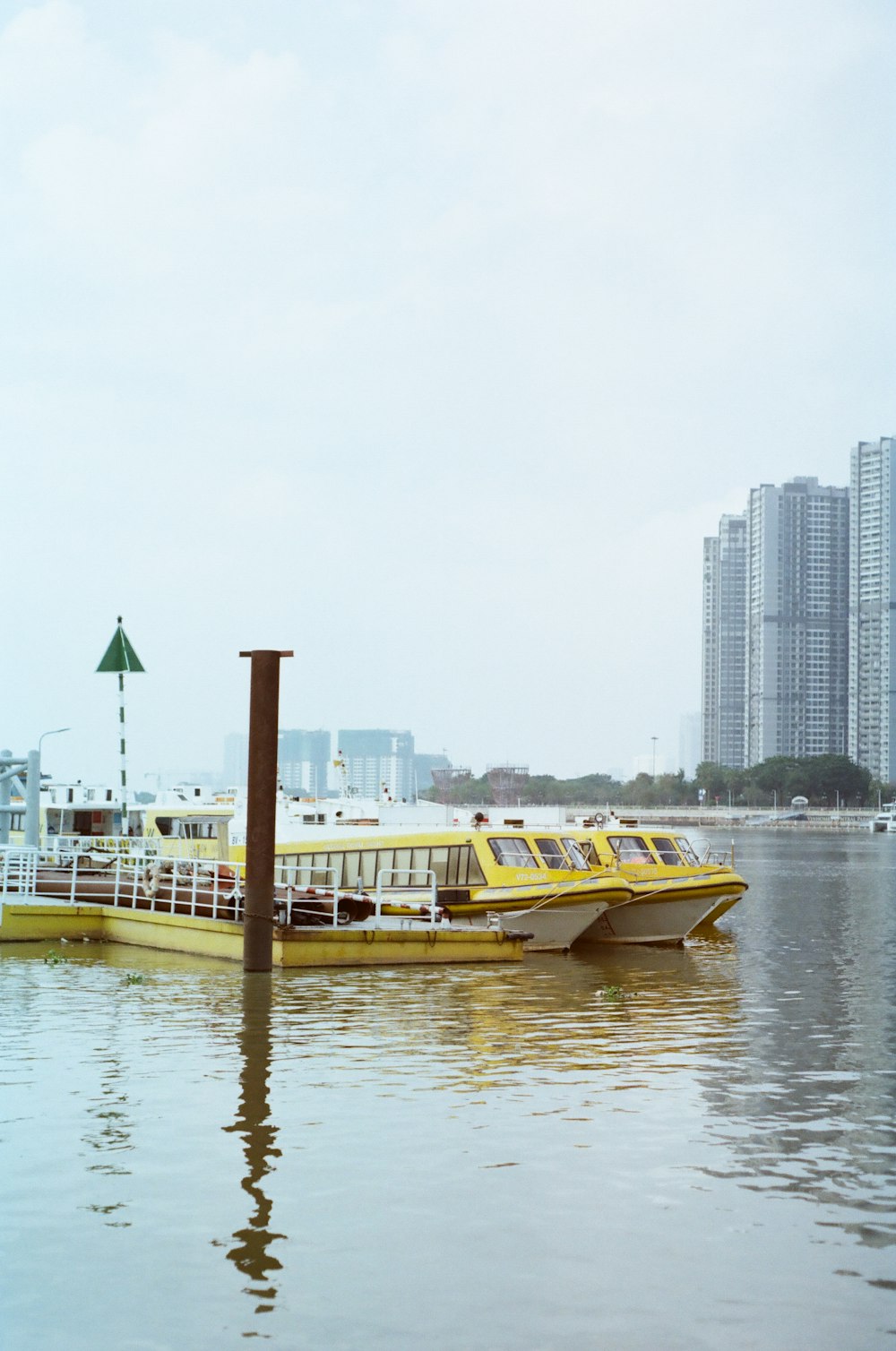 a yellow and white boat in a body of water