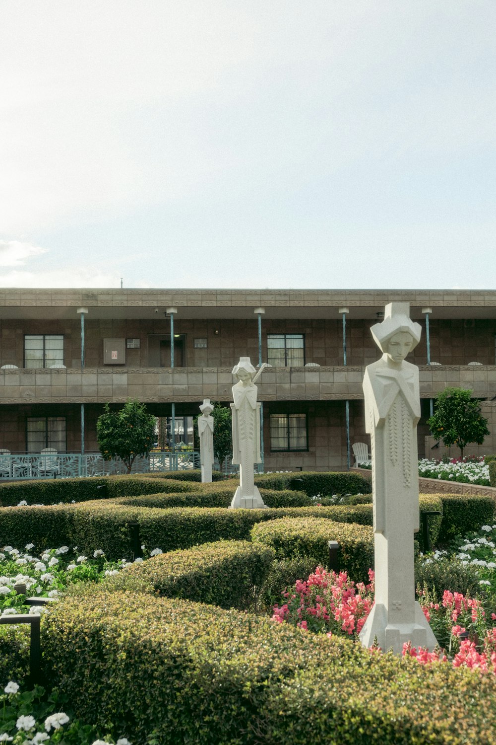 a large building with a garden in front of it