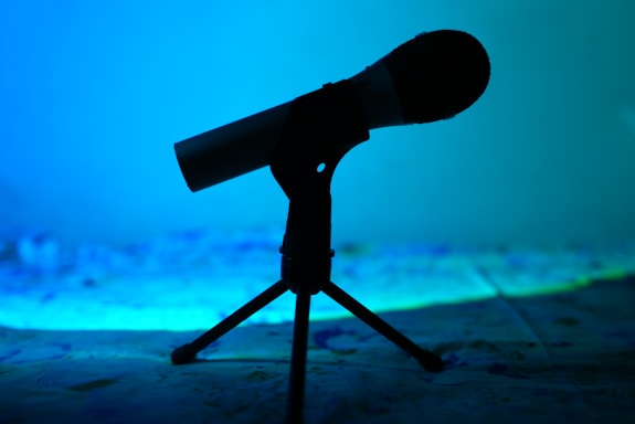 A serene image of a microphone set against a backdrop of musical notes.