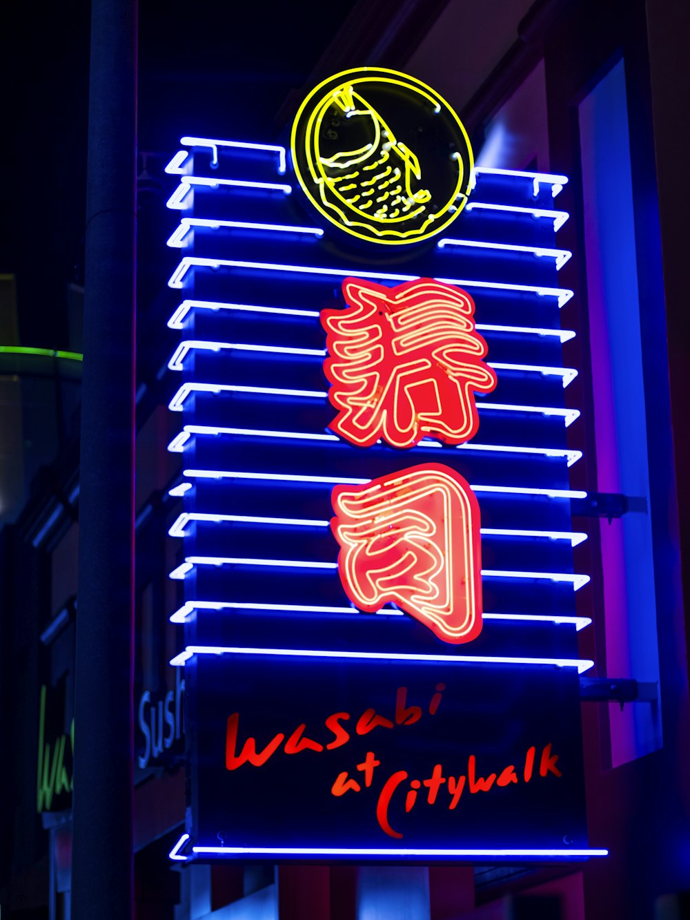 a neon sign that is on the side of a building