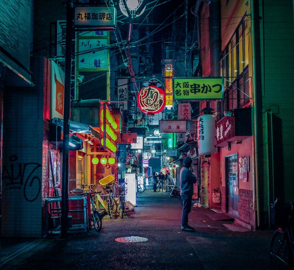 a man standing in an alley way at night