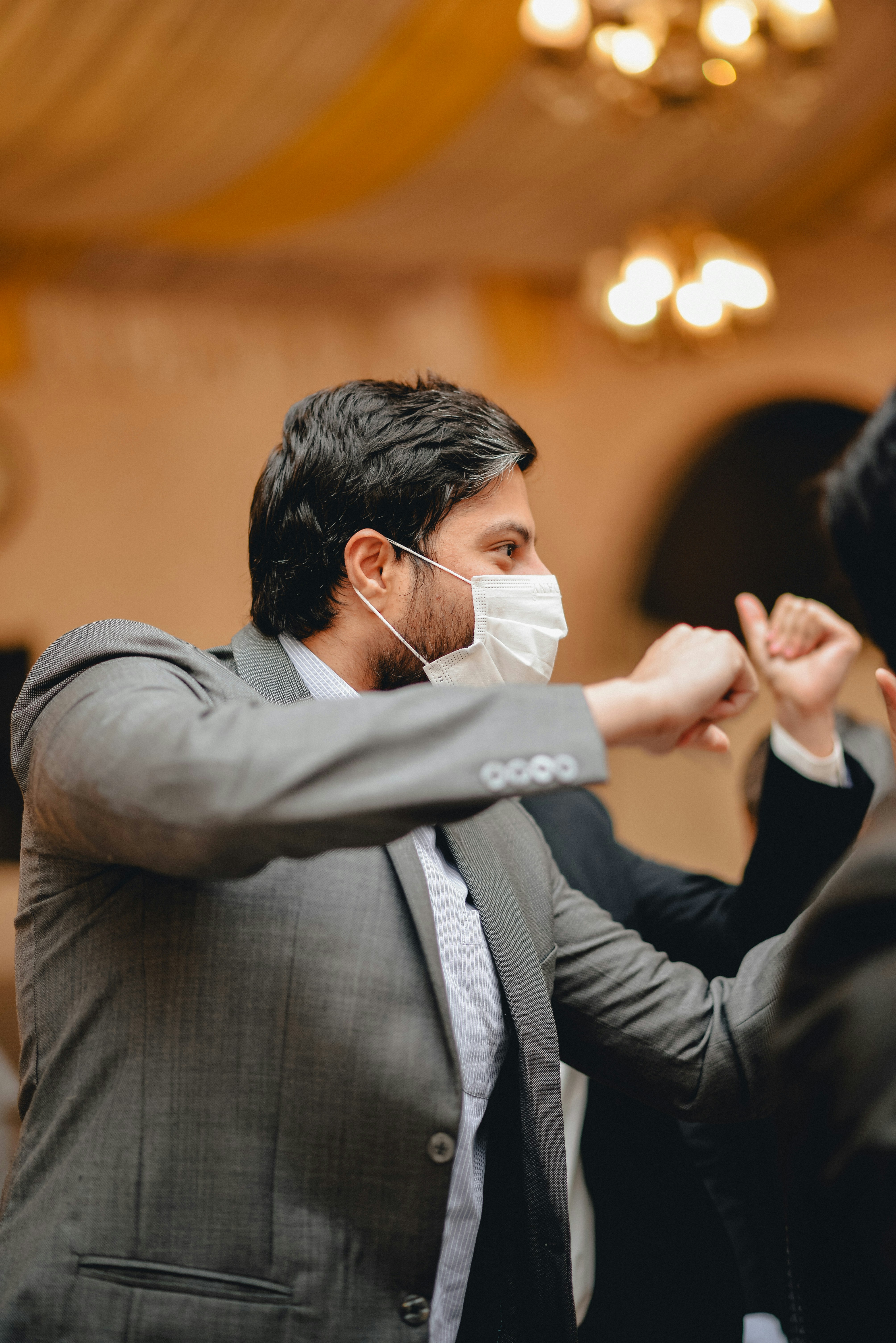 a man in a suit and mask is dancing
