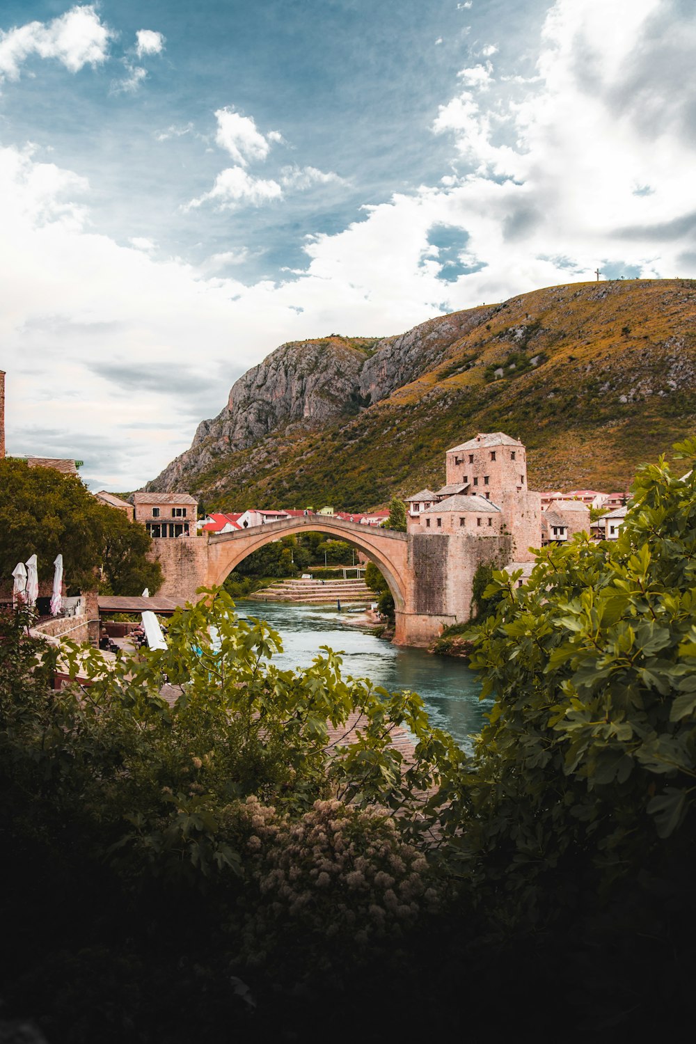 a bridge over a river with a building in the background