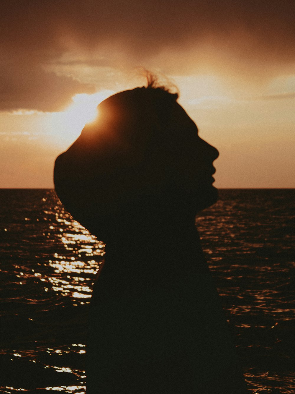 a person standing in front of a body of water