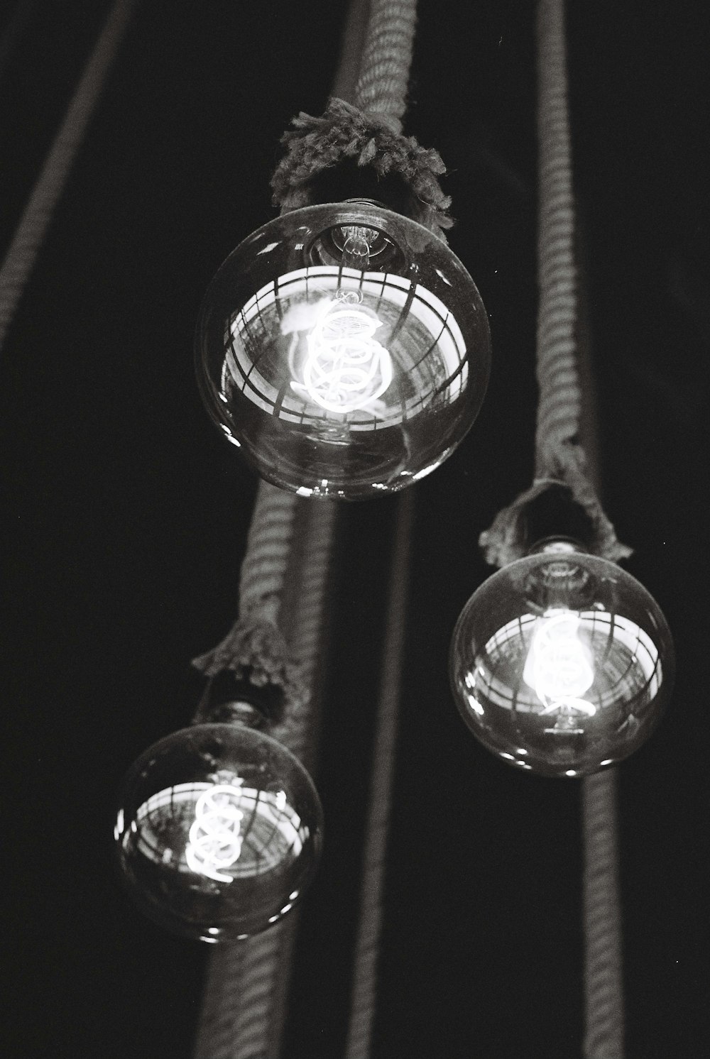 a group of lights hanging from a rope